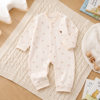 Sweet Peach Baby Romper - Full front view laid flat on nursery rug